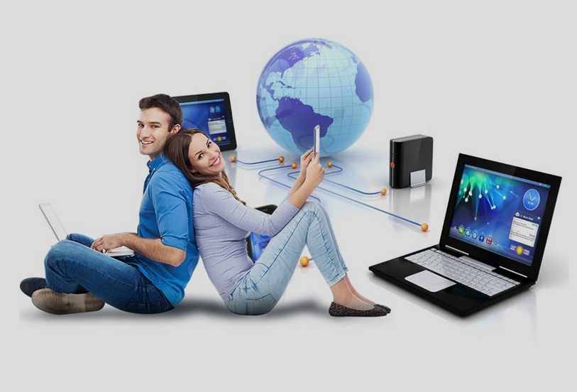 A man and woman sitting on the ground with laptops.